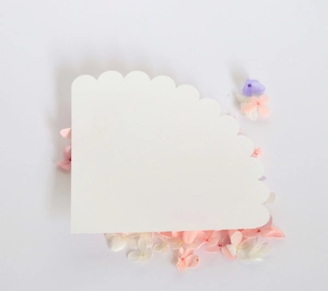 Close-up of a white scalloped edge wedding petal cone made of premium kraft paper