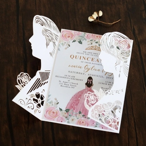 Detail of laser-cut wedding invitation featuring rose patterns and a Quinceañera theme