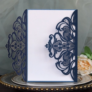 Detailed laser-cut floral pattern on navy blue pearlescent wedding invitation cover