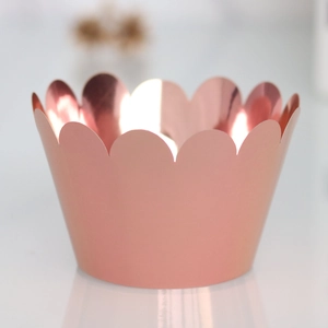 Detailed view of rose gold cupcake liners with wave edges and shiny mirror interior