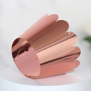 Detail of rose gold mirror finish cupcake wrapper with laser cut petal edges