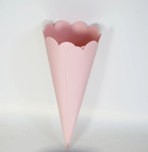 Pink cone-shaped paper container with elegant scalloped edges for wedding confetti