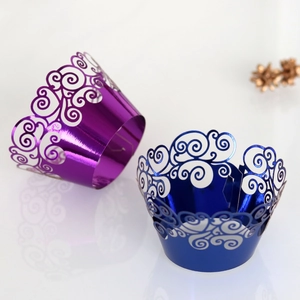 Close-up of laser-cut metallic purple and blue cupcake wrappers with hollow cloud patterns