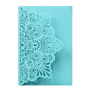Detailed laser-cut mandala floral patterns on a Tiffany blue wedding invitation card