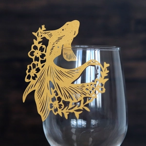 Golden laser-cut goldfish wine glass card with intricate floral patterns for weddings