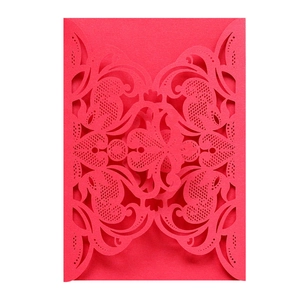 Detailed laser cut red invitation cover with intricate European floral lace patterns