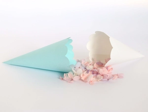 Close-up of light blue and white scalloped edge wedding petal cones with dried flowers