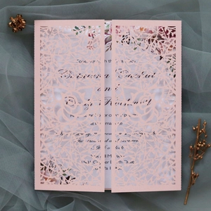 Detailed laser-cut pink wedding invitation shell with elegant floral and vine patterns