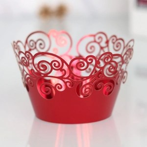 Close-up of red laser-cut cupcake wrapper with elegant pearlescent paper texture