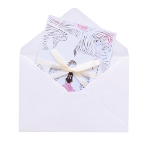 Laser-cut wedding invitation featuring hollow silhouette design and cream satin ribbon