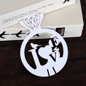 Detailed laser-cut white cardstock diamond ring placeholder with heart and bird design