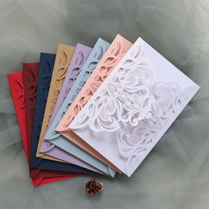 Detailed laser-cut floral patterns on assorted colorful wedding invitation envelopes