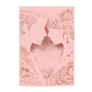 Detail of pink laser-cut wedding card featuring romantic silhouettes and rose lace patterns