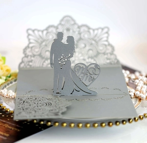 Detail of silver laser-cut pop-up wedding card featuring Mr & Mrs silhouettes
