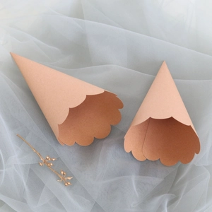 Detail of kraft paper confetti cones with scalloped petal edges for wedding party decor