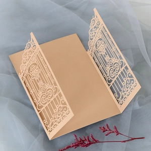Detail of laser-cut European floral pattern on champagne gold wedding invitation card