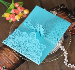 Detail of sky blue 3D pop-up wedding invitation with intricate laser-cut lace floral pattern