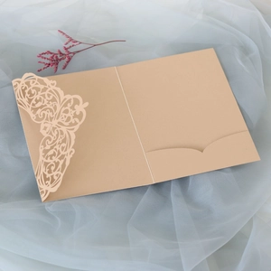 Detailed laser-cut lace champagne gold invitation cover with elegant butterfly pattern