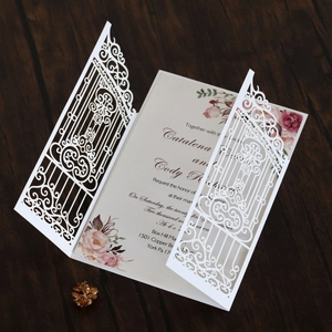 Detailed laser-cut gatefold wedding invitation with floral printed inner card on wood