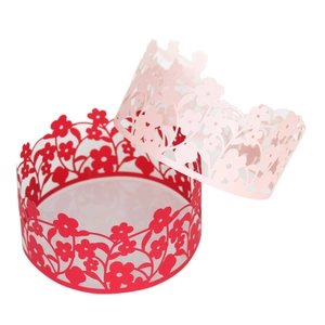 Intricate laser-cut flower cake wrappers in red and pink for wedding and party decor