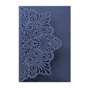 Detailed laser-cut dark blue wedding invitation sleeve with floral mandala pattern