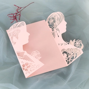 Detail of pink laser-cut wedding invitation featuring bride and groom silhouette and roses