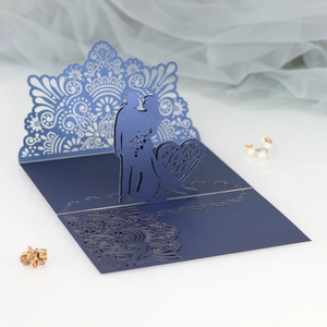 Macro shot of 3D laser-cut Mr & Mrs wedding card with intricate hollow heart patterns