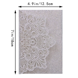 Detailed view of silver glitter wedding card with laser-cut lace mandala patterns