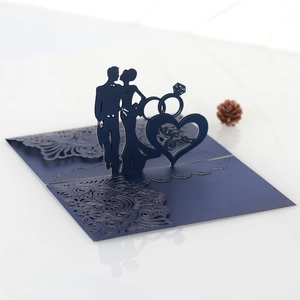 Detail of 3D laser-cut wedding invitation with Mr & Mrs heart and navy blue silhouette