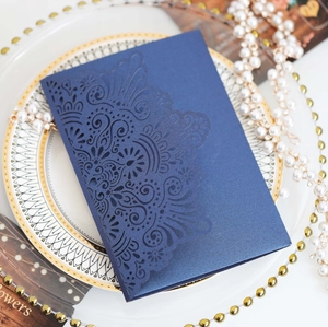 Detailed laser cut navy blue wedding invitation cover with elegant floral patterns