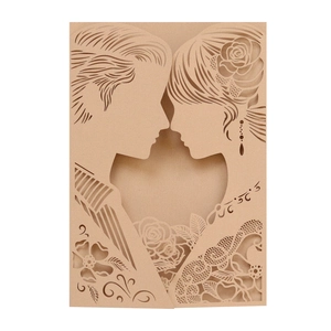 Close-up of laser-cut kraft wedding card featuring a heart-shaped bride and groom