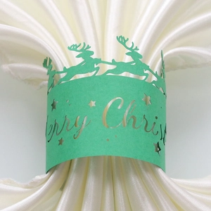 Detail of green laser-cut reindeer napkin ring with Merry Christmas cutout text