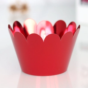 Detail of red metallic cupcake wrappers with elegant laser-cut scalloped wave edges