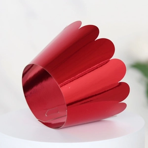 Detail of red metallic mirror cupcake wrapper with elegant laser cut wave edges