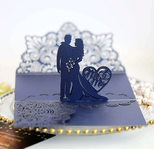 Detail of laser-cut navy blue wedding invitation featuring Mr & Mrs heart silhouette