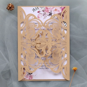 Detail of laser-cut light blue lace wedding invitation with floral insert on mesh