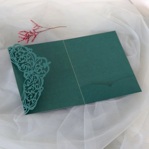 Detailed laser-cut lace floral pattern on dark green pocket folder wedding invitation