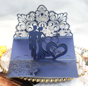 Detail of 3D laser-cut wedding card featuring dark blue Mr & Mrs silhouette and rings