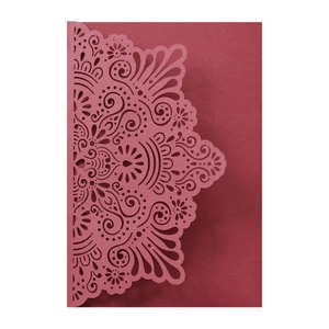 Detailed laser-cut mandala patterns on burgundy wedding invitation card cover