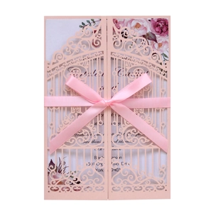 Pink laser-cut wedding invitation card with ribbon bow and floral inner page