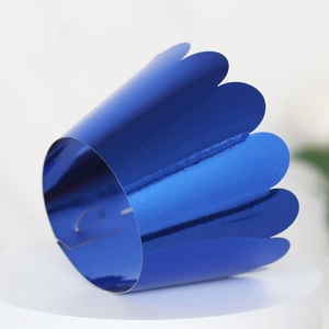 Close-up of laser-cut wave edge cupcake liners with reflective blue mirror finish