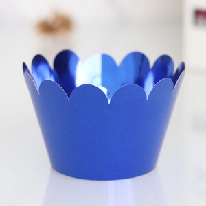 Macro detail of dark blue metallic cupcake liners with elegant scalloped wave edges