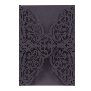 Detailed laser-cut hollow floral pattern on a dark purple elegant wedding invitation card