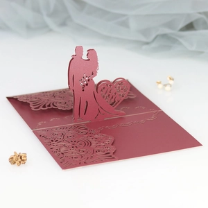 Detail of laser-cut 3D pop-up wedding card in burgundy with Mr & Mrs heart design