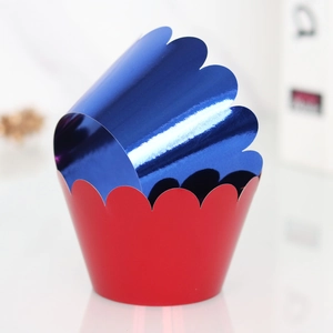 Close-up of metallic blue and matte red laser-cut wave cupcake wrappers for party decor
