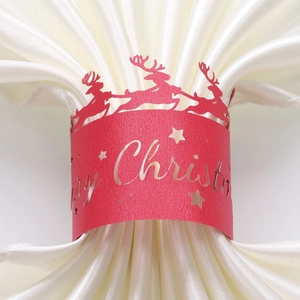 Detail of red pearl paper napkin ring with laser-cut reindeer and Merry Christmas text
