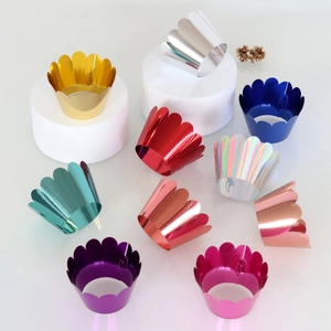 Close-up of laser-cut metallic cupcake liners with reflective mirror wave edges
