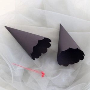 Close-up of black kraft paper flower cones with scalloped edges for wedding confetti