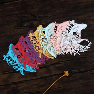 Macro view of laser-cut goldfish paper decorations with intricate floral hollow patterns
