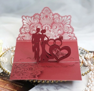 Detailed laser-cut 3D wedding invitation with Mr & Mrs silhouette and intricate heart patterns